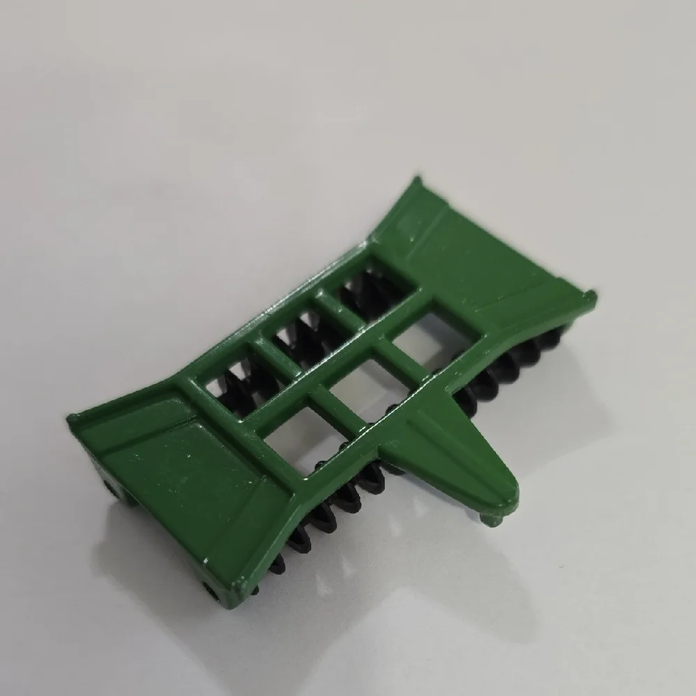 Toy John Deere combine corn head, likely an Ertl 1/64 scale model.